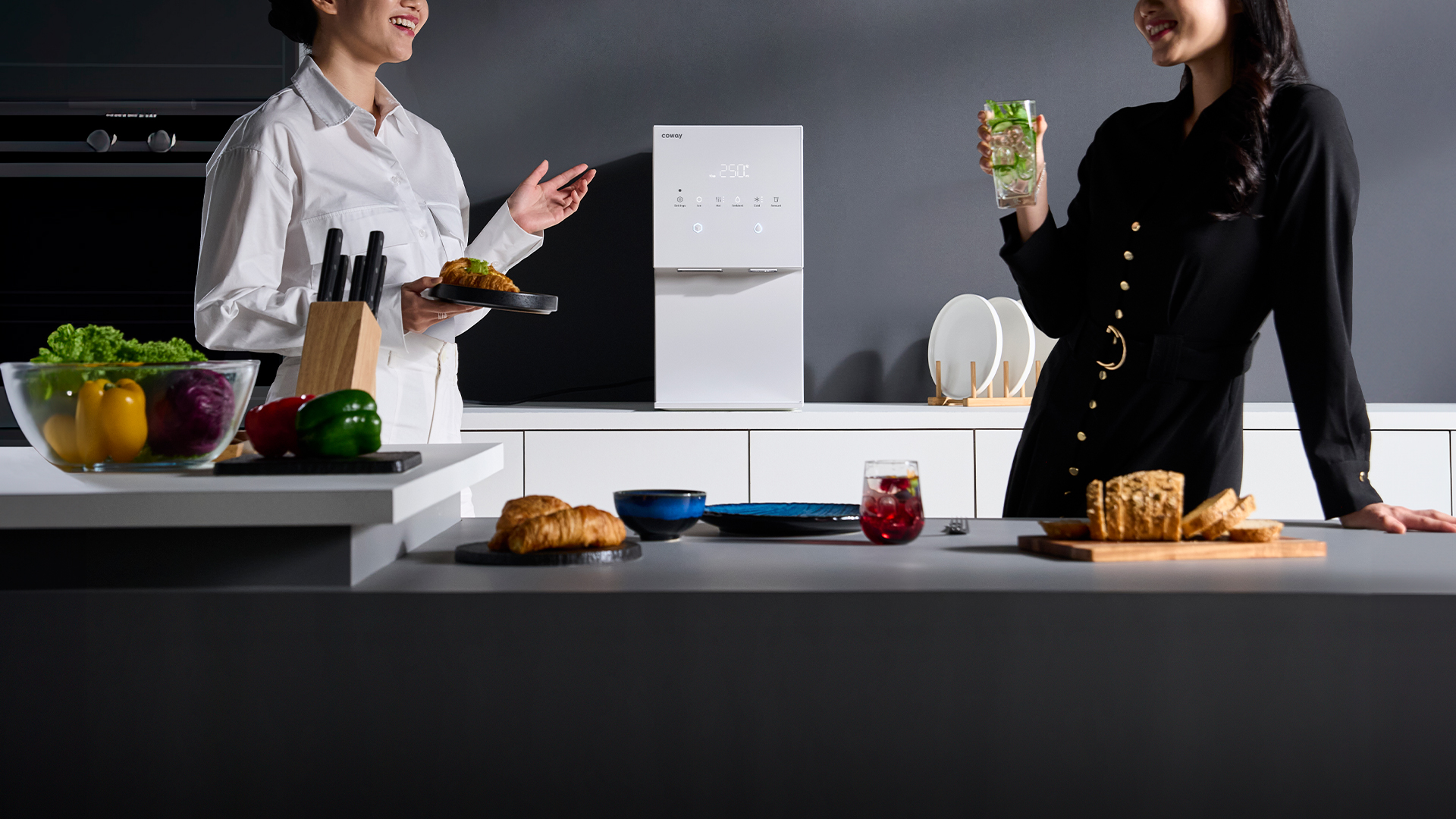 Two people sharing iced drinks and food beside the Coway Ais on a kitchen island