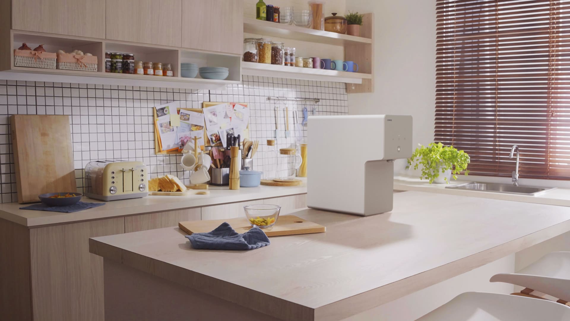 Coway Cinnamon on a kitchen island in a bright, minimalist home kitchen