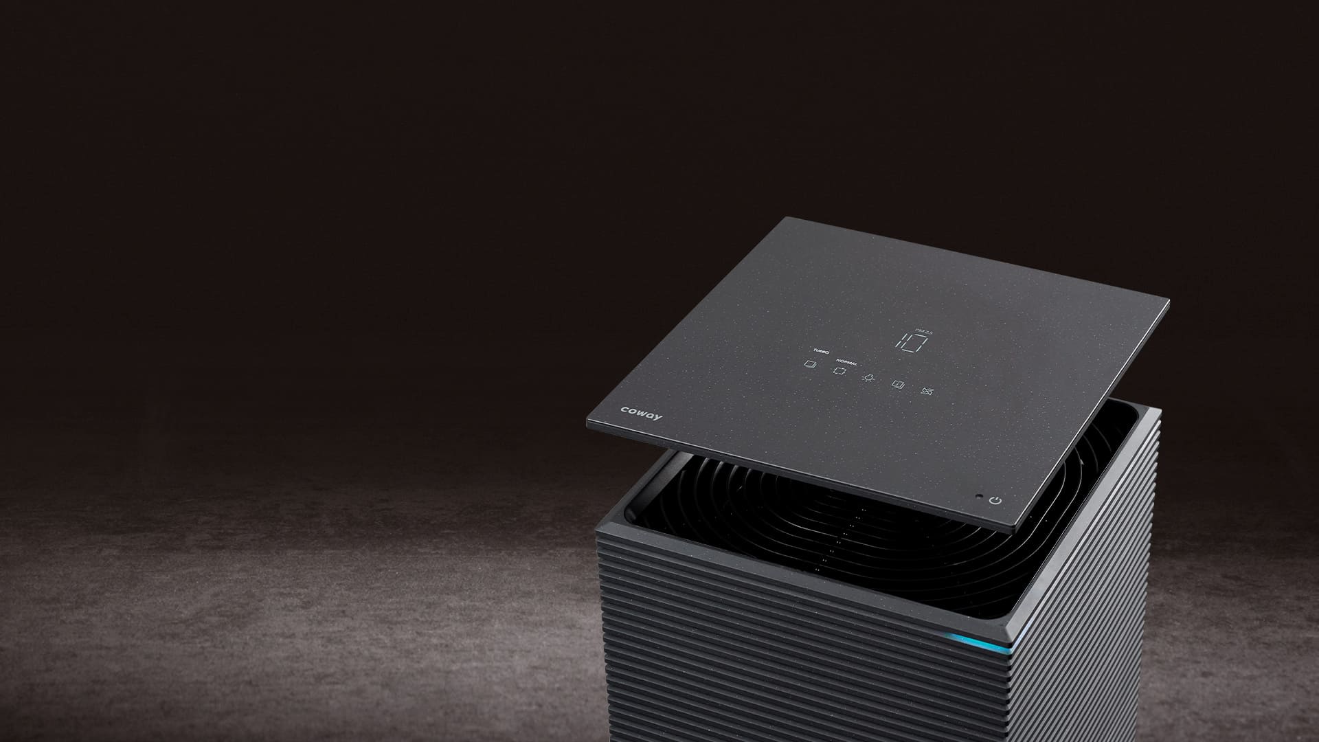 The Coway Noble glass top lifted to reveal its hidden touch display