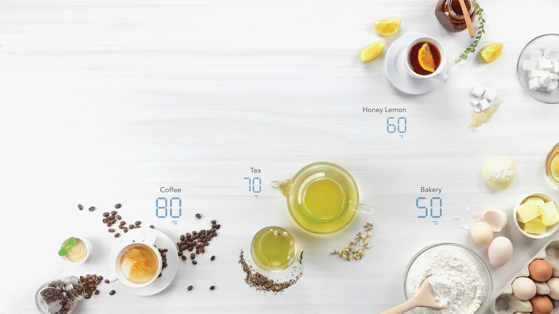 A bright table laid with coffee, tea, honey lemon and baking, each labelled with its ideal water temperature