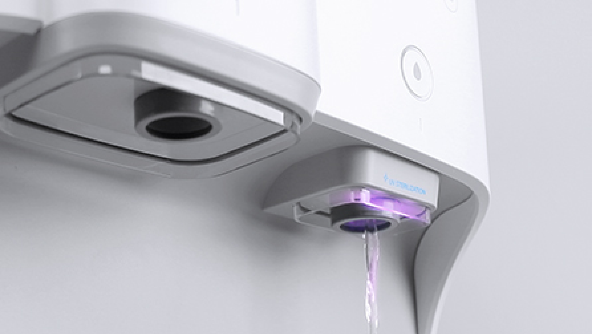 Close-up of the Coway Ombak dispenser with UV light sterilising the water outlet