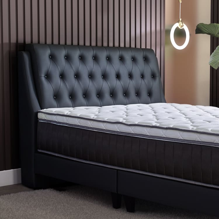Prime II Series mattress with dark grey bed frame, side view